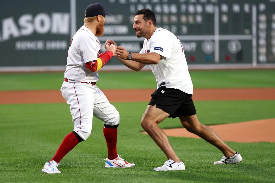 BOSTON, MASSACHUSETTS - SEPTEMBER 08: Milan Lucic of the Boston Bruins pretends to fight with Justin Turner #2 of the Boston Red Sox before the game between the Boston Red Sox and the Baltimore Orioles  at Fenway Park on September 08, 2023 in Boston, Massachusetts. (Photo by Maddie Meyer/Getty Images)