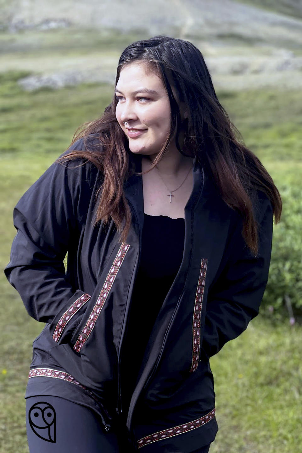 This undated photo shows Sara Bioff wearing an Atmik, a water-proof garment made by her mother, Alice Bioff, that resembles the traditional Alaska Native garment called a kuspuk in Nome, Alaska. The garment was inspired by a tourist Alice Bioff met in 2016 when she was a tour guide, and she hopes the $600 million expansion of the Port of Nome will translate into support of Nome stores and Indigenous artists. (Alice Bioff via AP)