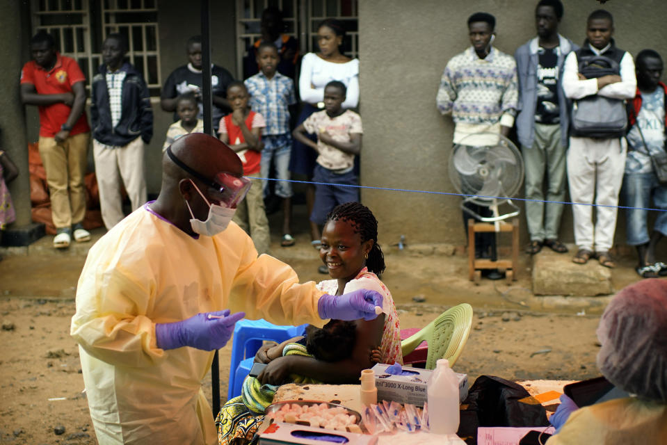 In this photo taken on Saturday, July 13, 2019, a nurse vaccinates a child against Ebola in Beni, Congo DRC. The World Health Organization has declared the Ebola outbreak an international emergency after spreading to eastern Congo's biggest city, Goma, this week. More than 1,600 people in eastern Congo have died as the virus has spread in areas too dangerous for health teams to access. (AP Photo/Jerome Delay)