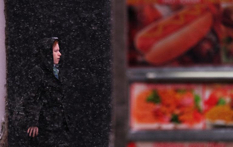 A woman waits to get a taxi cab during a winter storm on March 5, 2015 in New York