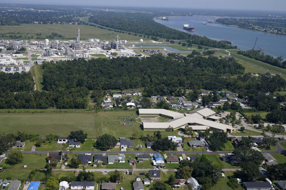 FILE - The Fifth Ward Elementary School and residential neighborhoods sit near the Denka Performance Elastomer Plant, back, in Reserve, La., Sept. 23, 2022. More than 20 Republican attorneys general on Tuesday, April 16, 2024, asked the EPA to stop investigating environmental policies that disproportionately harm Black people but aren't intentionally discriminatory. The petition is unlikely to convince the Biden administration to back away from an issue EPA Administrator Michael Regan has taken pains to highlight, like visiting the industrial stretch of Louisiana typically called Cancer Alley. (AP Photo/Gerald Herbert, File)