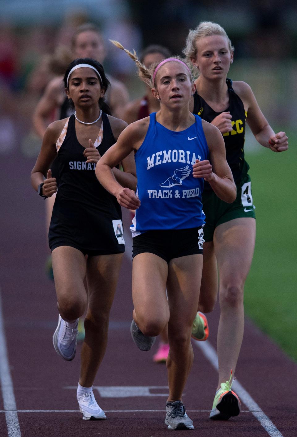 Memorial's Jacqueline Brasseale, center, competes in the 3200 Meter Run during the IHSAA Girls Track & Field Regionals at the Central High School's Central Stadium Tuesday evening, May 24, 2022. Brasseale finished in third place with a time of 11:33.15.