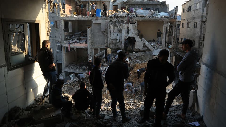 Palestinians inspect the destruction around residential buildings following Israeli air strikes in the Rafah refugee camp in southern Gaza on December 1, 2023. - Said Khatib/AFP/Getty Images
