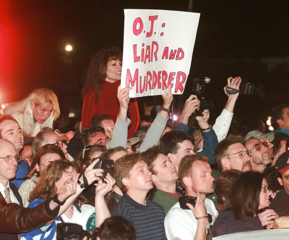 A crowd reacts to O.J. Simpson leaving Los Angeles County Superior Court, Tuesday, Feb. 4, 1997. The trial happened after his arrest following the Bronco chase (AP)