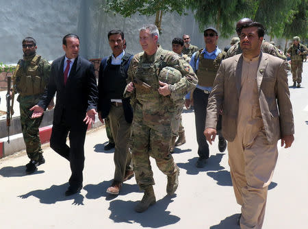 U.S. Army General John Nicholson, commander of Resolute Support forces and U.S. forces in Afghanistan,(C) walks with Afghan officials during an official visit in Farah province, Afghanistan May 19, 2018. REUTERS/James Mackenzie