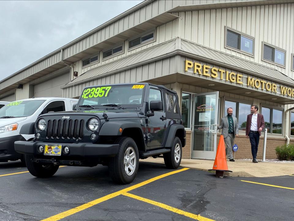 Alex Tovstanovsky, owner of used-car dealer Prestige Motor Works, checks on depleted inventory with his general manager Ryan Caton after sales jumped in May following two down months because of the coronavirus disease (COVID-19) pandemic in Naperville, Illinois, U.S. May 28, 2020. Picture taken May 28, 2020.  REUTERS/Nick Carey