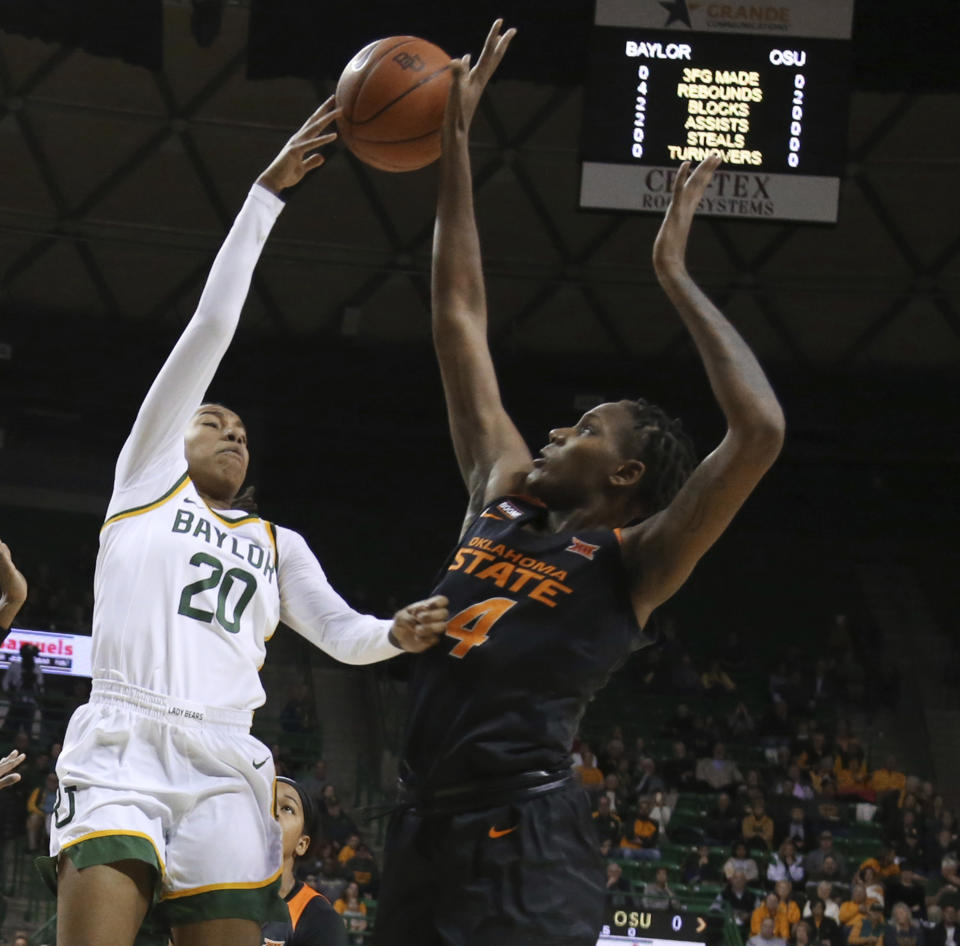 CORRECTS DATE Oklahoma State forward Natasha Mack, right, blocks the shot of Baylor guard Juicy Landrum, left, in the first half of an NCAA college basketball game, Sunday, Jan. 12, 2020, in Waco, Texas. (Rod Aydelotte/Waco Tribune Herald via AP)