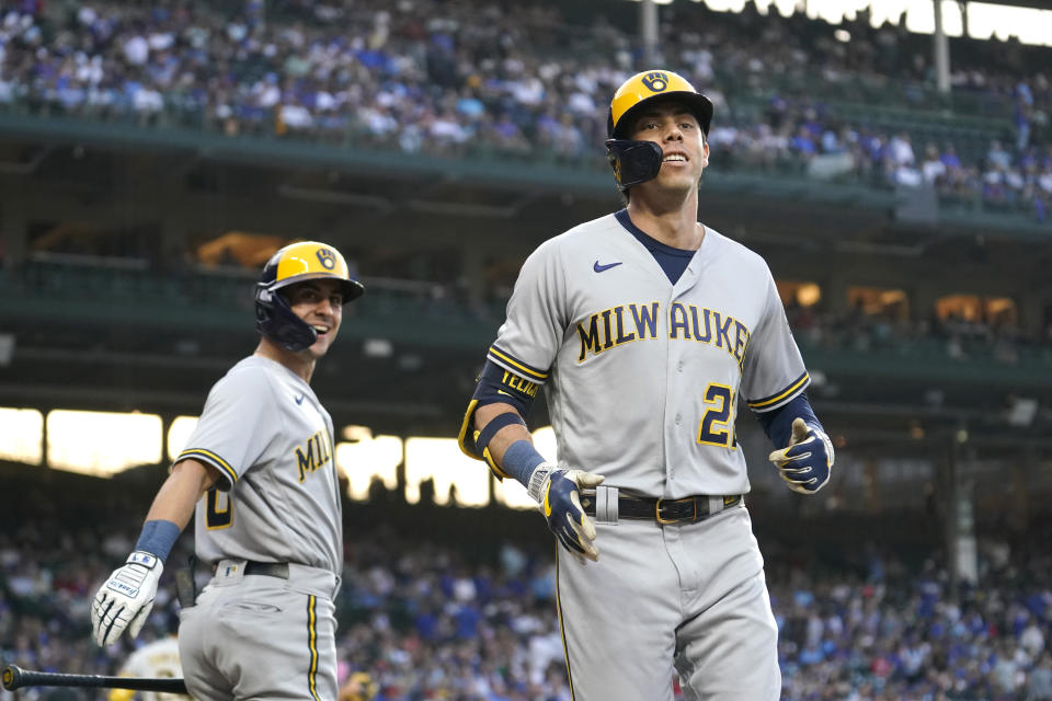 Milwaukee Brewers' Christian Yelich, right, smiles as he heads to the dugout past Sal Frelick after Yelich hit a home run off Chicago Cubs starting pitcher Jameson Taillon during the first inning of a baseball game Monday, Aug. 28, 2023, in Chicago. (AP Photo/Charles Rex Arbogast)
