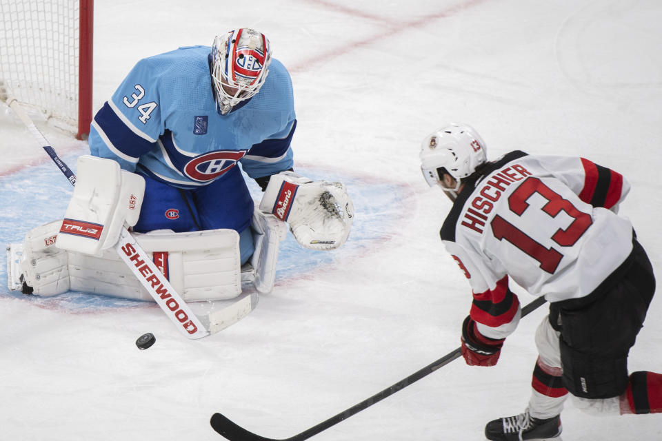 New Jersey Devils' Nico Hischier takes a shot on Montreal Canadiens goaltender Jake Allen during the second period of an NHL hockey game, Tuesday, Nov. 15, 2022 in Montreal. (Graham Hughes/The Canadian Press via AP)
