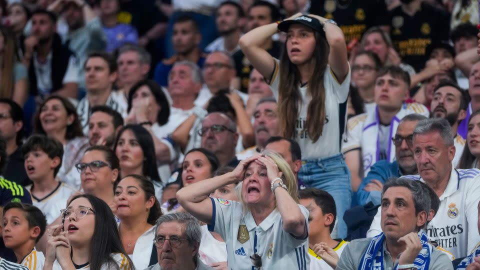 Real Madrid fans watch on nervously as the final plays out. - Paul White/AP