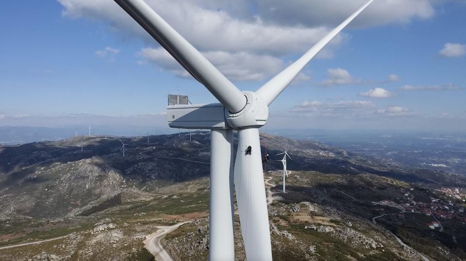 Sardo and his partner begin their descent down the blade of a wind turbine.