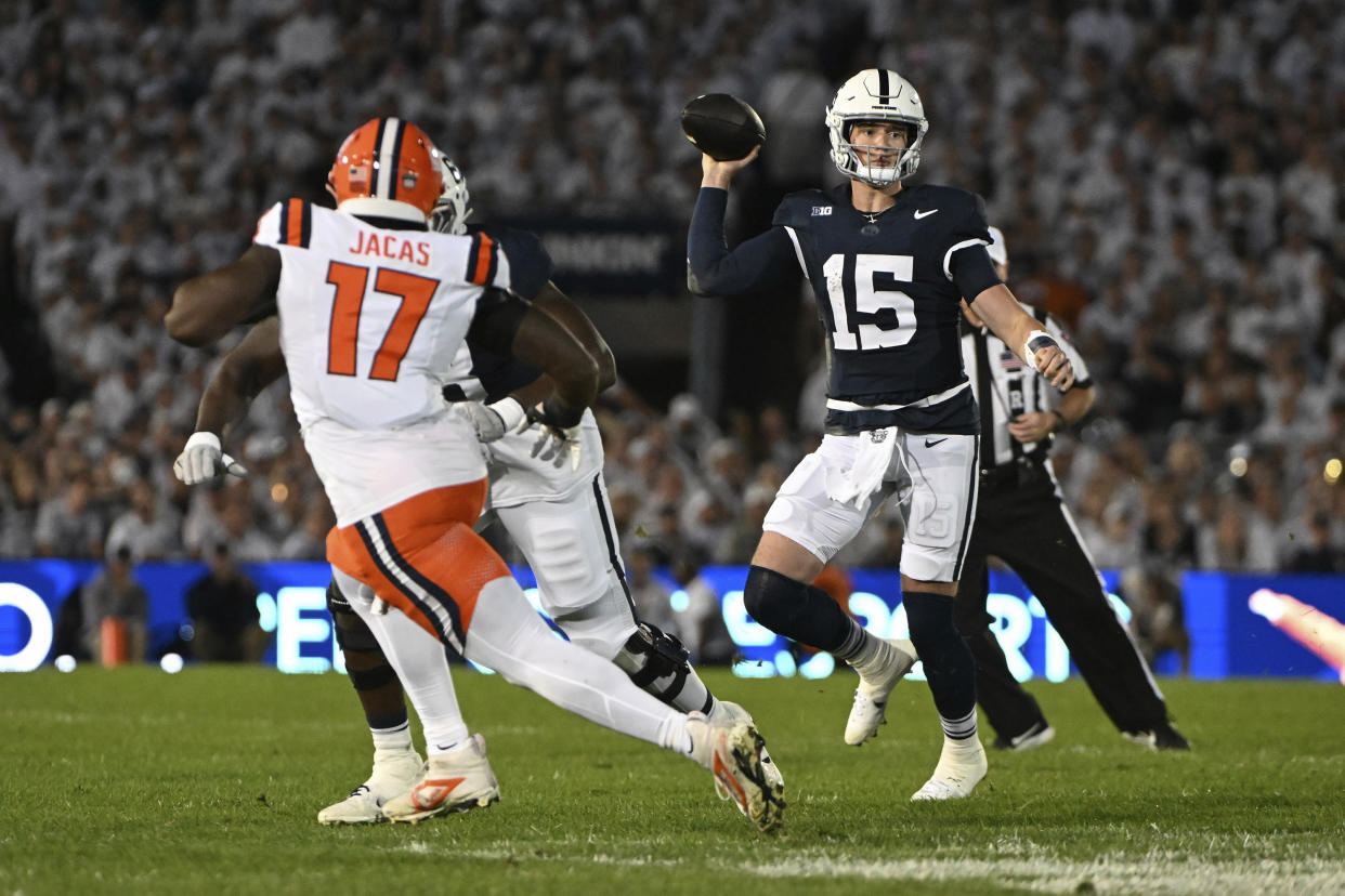 Penn State quarterback Drew Allar (15) throws a pass against Illinois linebacker Gabe Jacas (17) during the first quarter of an NCAA college football game, Saturday, Sept. 28, 2024, in State College, Pa. (AP Photo/Barry Reeger)