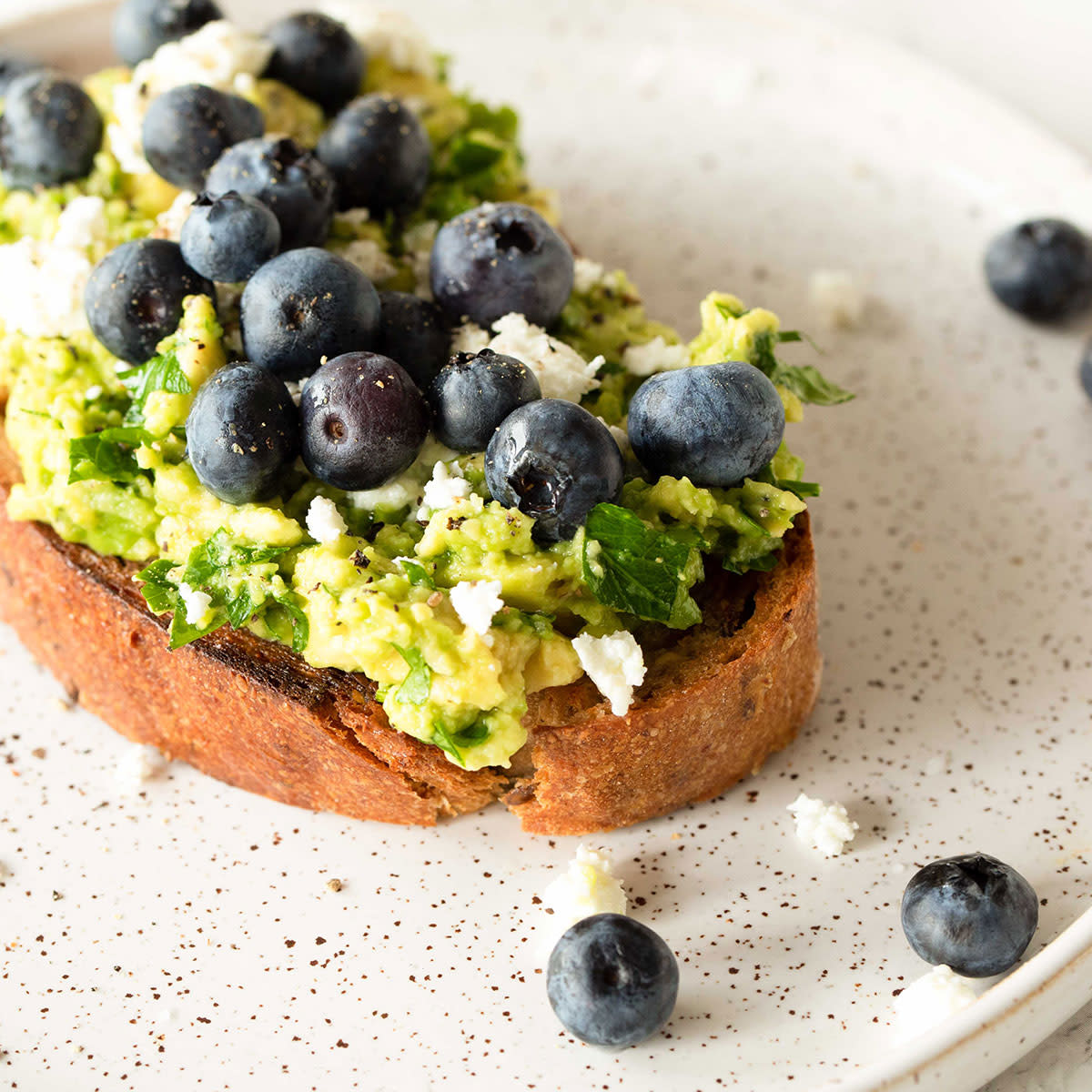 avocado toast topped with blueberries