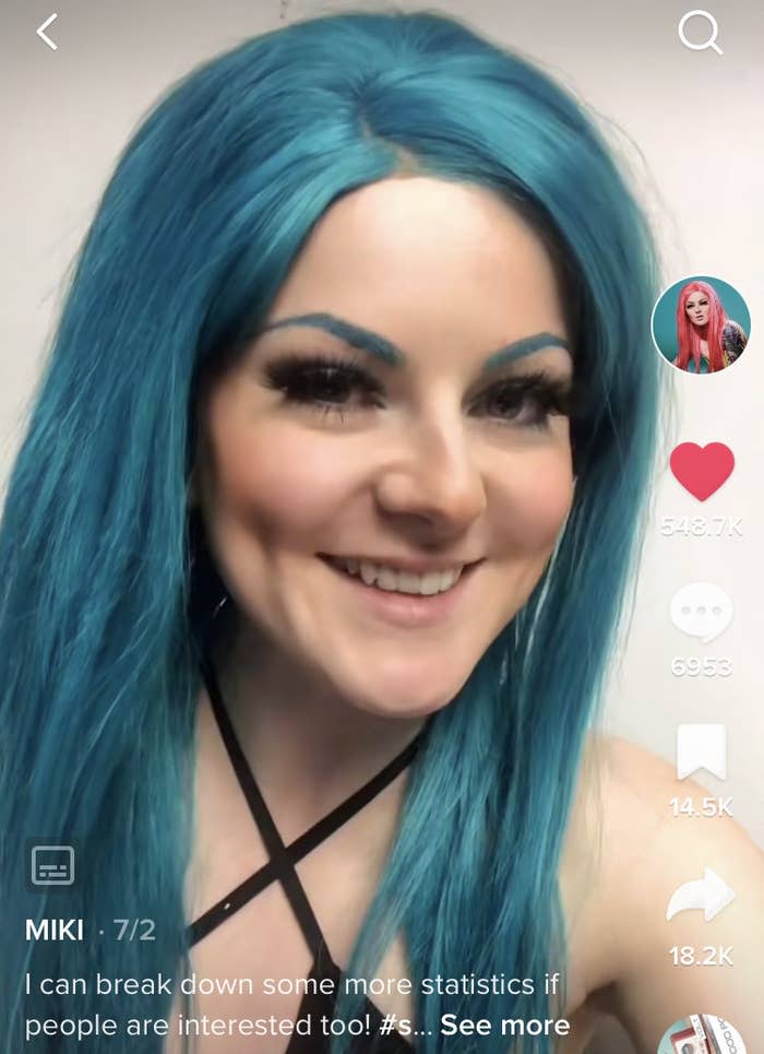 Miki wearing blue hair and smiling