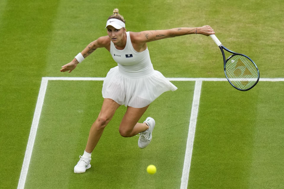 Czech Republic's Marketa Vondrousova returns to Ukraine's Elina Svitolina in a women's singles semifinal match on day eleven of the Wimbledon tennis championships in London, Thursday, July 13, 2023. (AP Photo/Kirsty Wigglesworth)