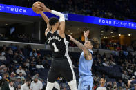 Memphis Grizzlies forward Brandon Clarke, right, defends against San Antonio Spurs center Victor Wembanyama (1) in the first half of an NBA basketball game Tuesday, April 9, 2024, in Memphis, Tenn. (AP Photo/Brandon Dill)
