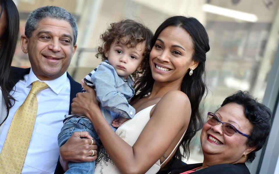 Zoey Saldana holding her son