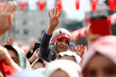 Supporters of Turkish President Tayyip Erdogan cheer during a ceremony in Istanbul, Turkey, March 26, 2017. REUTERS/Murad Sezer