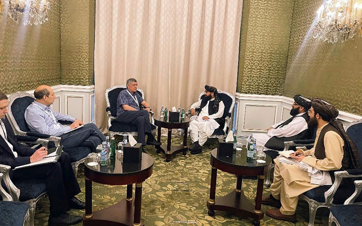 Zabihullah Mujahid,  the Taliban's chief spokesman, speaks with the Russian presidential envoy Zamir Kabulov during a meeting in Qatar last month