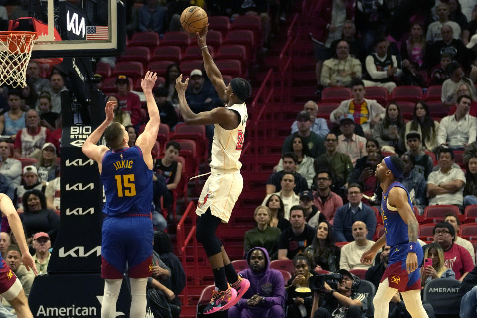 Miami Heat forward Jimmy Butler (22) goes to the basket as Denver Nuggets center Nikola Jokic (15) defends during the first half of an NBA basketball game, Monday, Feb. 13, 2023, in Miami. (AP Photo/Lynne Sladky)