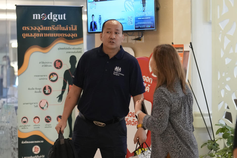 A staff member from British Embassy arrives at Samitivej Hospital in Bangkok, Thailand, Wednesday, May 22, 2024. A Singapore Airlines flight hit severe turbulence over the Indian Ocean and descended 6,000 feet (around 1,800 meters) in about three minutes, the carrier said Tuesday. A British man died and authorities said dozens of passengers were injured, some severely. (AP Photo/Sakchai Lalit)