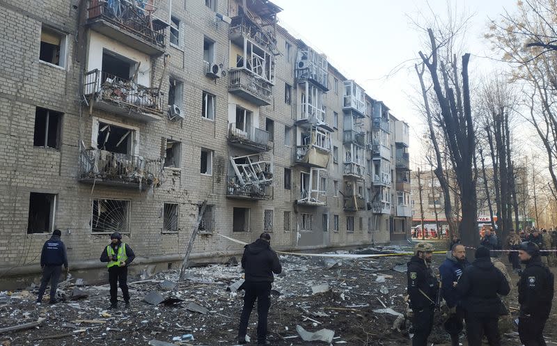 Police experts works at the site where buildings were damaged by a Russian military strike in Kharkiv