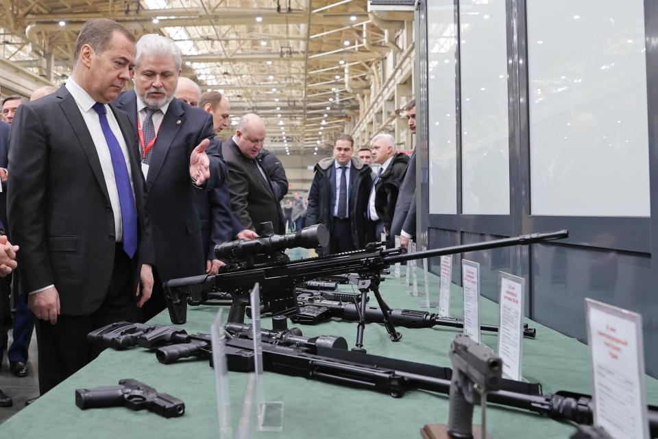 FILE - Deputy head of Russia's Security Council and chairman of the United Russia party Dmitry Medvedev, left, listens to General Director of the Kalashnikov Concern Vladimir Lepin, second left, while visiting the Kalashnikov Group plant in Izhevsk, Russia, Tuesday, Jan. 24, 2023. The United States on Thursday, Sept. 14, 2023, is sanctioning more than 150 businesses and people from Russia to Turkey, the United Arab Emirates and Georgia to try to crack down on evasion and deny the Kremlin access to technology, money and financial channels that fuel President Vladimir Putin’s war in Ukraine. (Ekaterina Shtukina, Sputnik Pool Photo via AP, File)