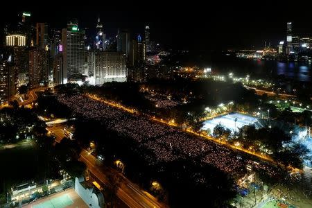 Thousands of people take part in a candlelight vigil to mark the 27th anniversary of the crackdown of pro-democracy movement at Beijing's Tiananmen Square in 1989, at Victoria Park in Hong Kong June 4, 2016. REUTERS/Bobby Yip