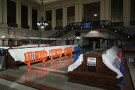 Tarps and fences block the seating area in the Hoboken Terminal waiting room in Hoboken, N.J., Tuesday, Oct. 27, 2020. Once a gleaming symbol of early 20th-century ambition and prosperity, the grand rail terminal now sits as a somber reminder of the daunting challenges facing mass transit in the New York region. (AP Photo/Seth Wenig)