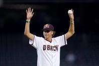 Jagger Eaton, the United States Olympic bronze medalist for men's street competition in skateboarding in the 2021 Tokyo Olympics, waves to cheering fans prior to throwing out the first pitch in a baseball game between Arizona Diamondbacks and the San Francisco Giants, Tuesday, Aug. 3, 2021, in Phoenix. (AP Photo/Ross D. Franklin)