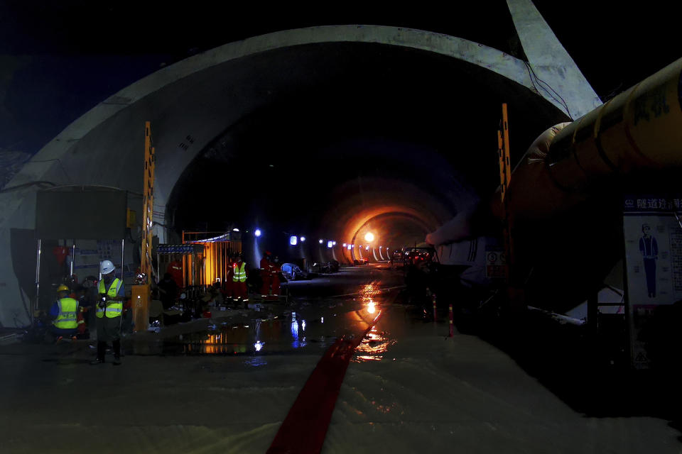 Rescuers work on a flooded tunnel in Zhuhai city in south China's Guangdong province Thursday, July 15, 2021. Divers have been dispatched in the search for 14 workers missing since water flooded a tunnel under construction in southern China three days ago, authorities said Sunday, July 18, 2021. (Chinatopix via AP)