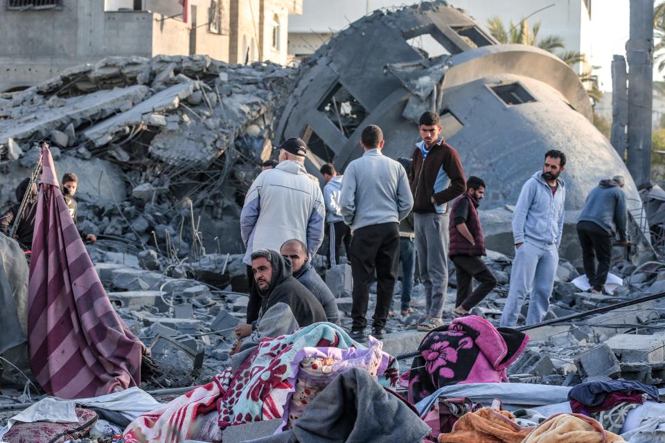 Palestinians stand amid the rubble of a mosque that was destroyed in Israeli strikes in Deir El-Balah in central Gaza on March 2, 2024, as battles continue between Israel and the militant group Hamas.