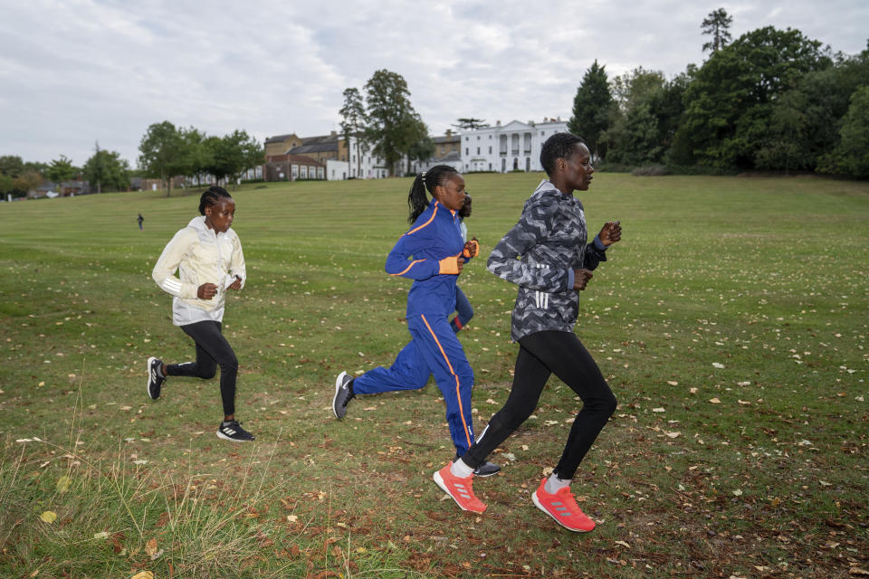 In this image issued by London Marathon Events, Kenya's Edith Chelimo, right, trains in the grounds of the official hotel and biosecure bubble in London, Monday Sept. 28, 2020, ahead of the elite-only 2020 London Marathon on Sunday Oct. 4. The 40th Race will take place on a closed-loop circuit around St James's Park in central London. (Bob Martin/London Marathon Events via AP)