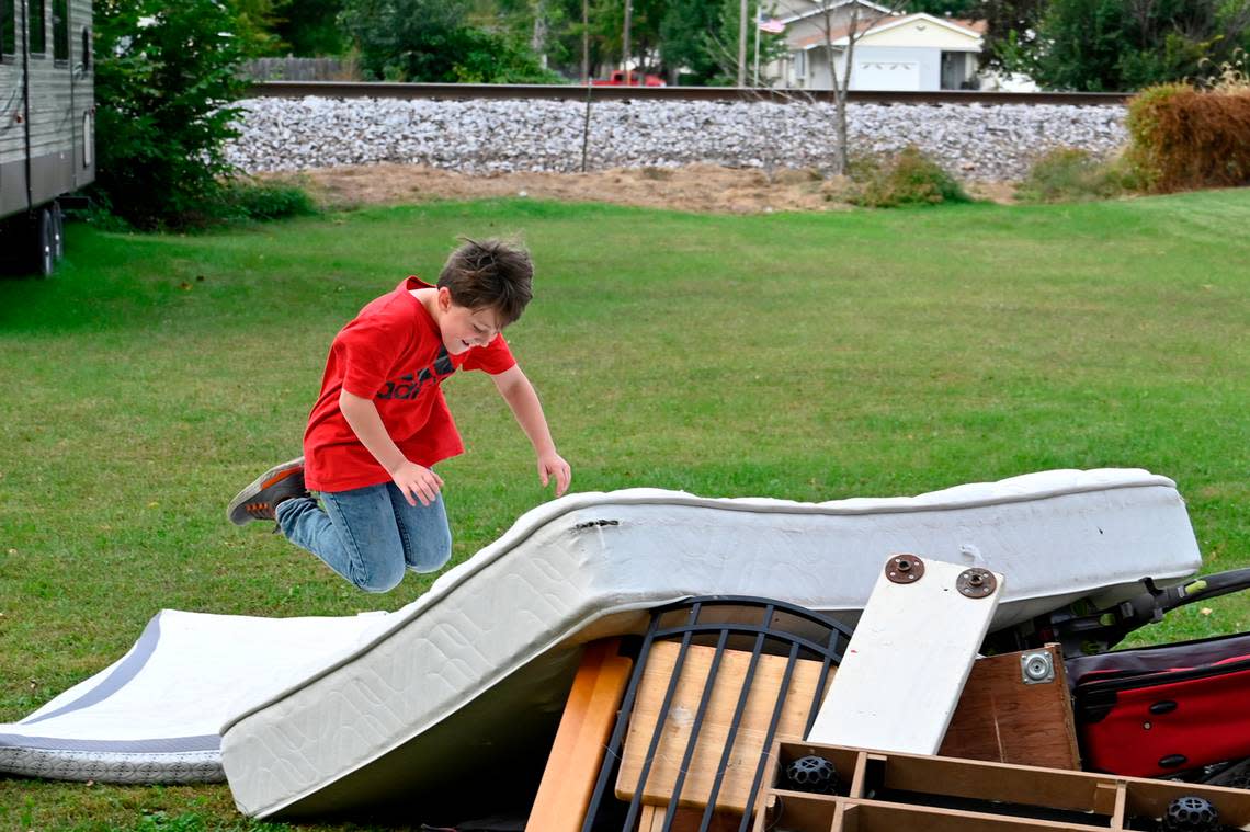 Drew Determann, 9, launched himself on a mattress set out for a bulky item pickup outside of his home in Camanache, Iowa. The Determann home, where kids often play outside, is about 100 feet from the railroad tracks.