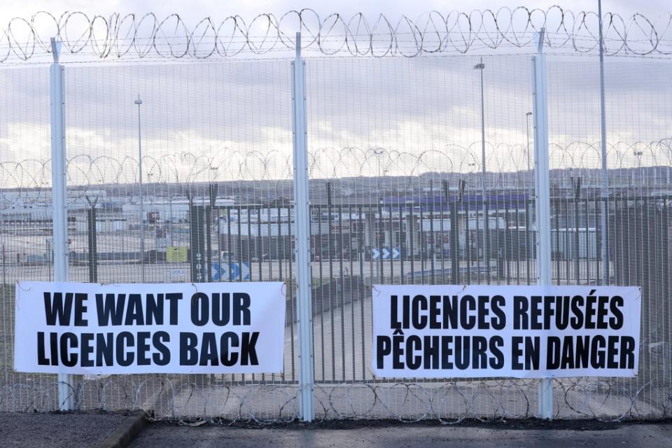 Banners installed by French fishermen are seen on the fences of the Eurotunnel Freight Terminal during a day of protests to mark their anger over the issue of post-Brexit fishing licenses (REUTERS)