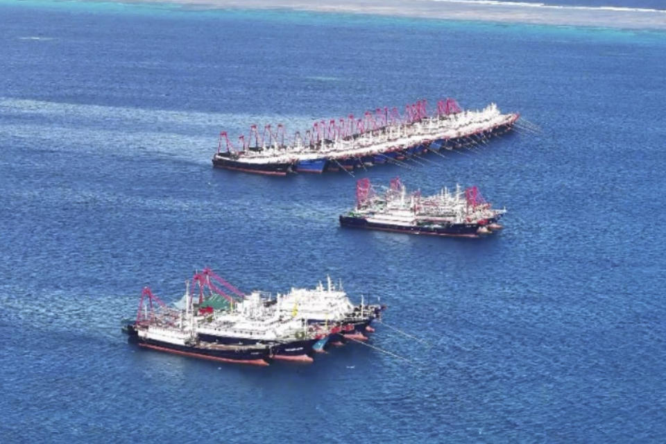 In this handout photo provided by the Philippine Coast Guard, suspected Chinese militia ships stay near the Philippine-claimed reef called Whitsun, locally known as Julian Felipe reef, at the disputed South China Sea on Saturday Dec. 2, 2023. Philippine Coast Guard said on Dec. 3 that they have monitored more than a hundred suspected Chinese militia ships have gathered around the reef near Palawan province, Philippines. (Philippine Coast Guard via AP)