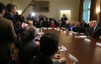 U.S. President Donald Trump listens to a question from CNN White House correspondent Jim Acosta (L) as the president hosts a "roundtable discussion on border security and safe communities" with state, local, and community leaders in the Cabinet Room of the White House in Washington, U.S., January 11, 2019. REUTERS/Leah Millis