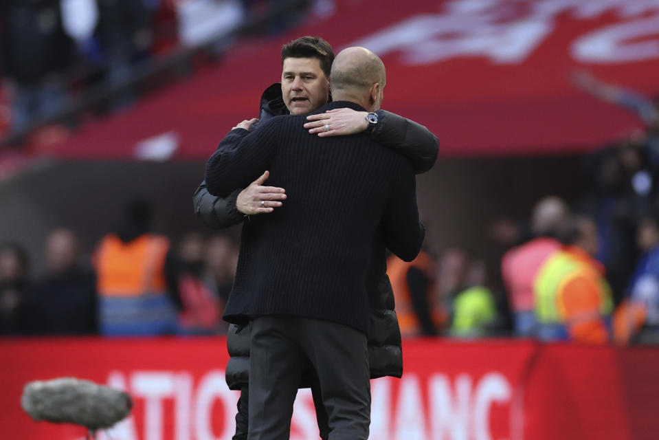 Manchester City's head coach Pep Guardiola, right, hugs Chelsea's head coach Mauricio Pochettino at full time of the English FA Cup semifinal soccer match between Manchester City and Chelsea at Wembley stadium in London, Saturday, April 20, 2024. Manchester City won 1-0. (AP Photo/Ian Walton)