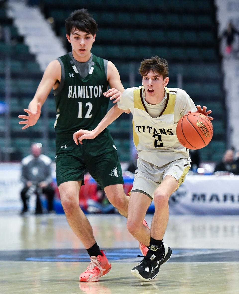 Avoca/Prattsburgh's Macoy Putnam, right, is defended by Hamilton's Luke Jackson during a NYSPHSAA Class D Boys Basketball Championship semifinal in Glens Falls, N.Y., Saturday, March 18, 2023. Avoca/Prattsburgh advanced to the Class D final with a 64-41 win over Hamilton-III.