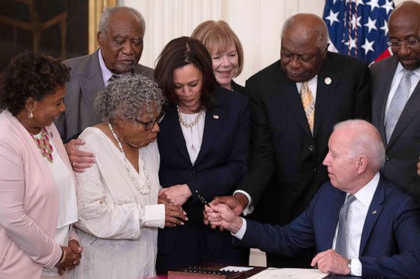 PHOTO: Vice President Kamala Harris watches as Opal Lee (2nd L), the activist known as the grandmother of Juneteenth, is given a pen after President Joe Biden signs the Juneteenth National Independence Day Act, in the White House, June 17, 2021. (Jim Watson/AFP via Getty Images)
