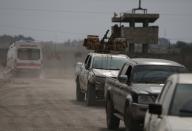 Turkey-backed Syrian rebel fighters return from the Syrian border town of Tal Abyad, as they are pictured in Akcakale