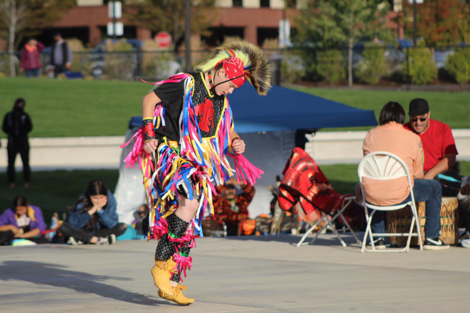 FILE - Tobin Waller, of Salem, Ore., a member of the Ojibwe tribe, dances to drummers pounding a beat as Oregon celebrates its first-ever Indigenous Peoples Day, Oct. 11, 2021, in Salem, Ore. Native American people will celebrate their centuries-long history of resilience on Monday, Oct. 9, 2023, through ceremonies, dances and speeches. The events across the United States will come two years after President Joe Biden officially commemorated Indigenous Peoples Day. (AP Photo/Andrew Selsky, File)