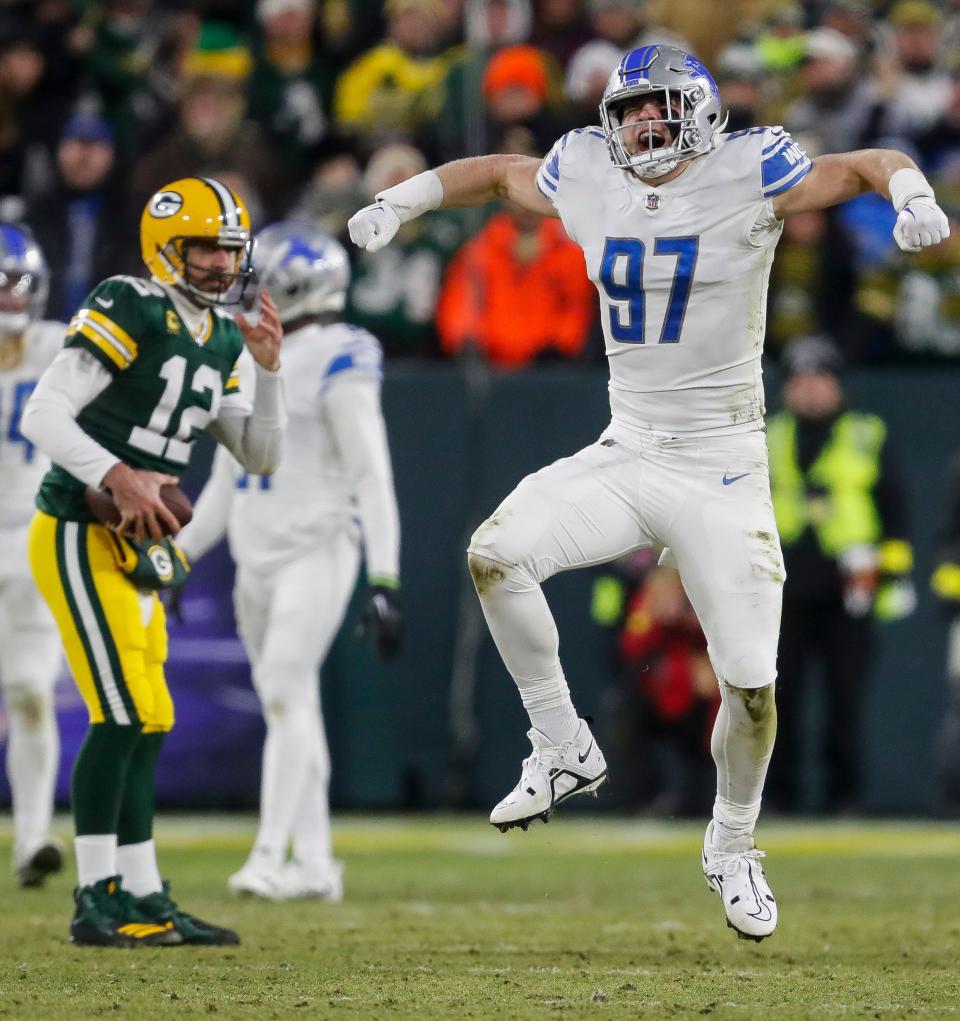 Detroit Lions defensive end Aidan Hutchinson (97) celebrates after sacking Green Bay Packers quarterback Aaron Rodgers.