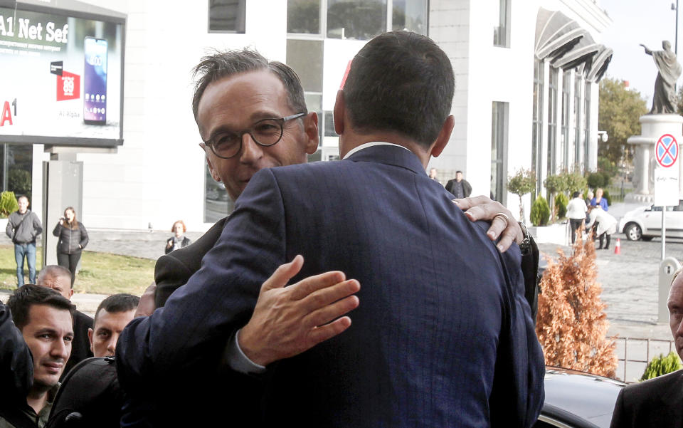 German Foreign Minister Heiko Maas, left, is welcomed by his North Macedonia counterpart Nikola Dimitrov, at the ministry of foreign affairs in Skopje, North Macedonia, on Wednesday, Nov. 13, 2019. Maas arrived Wednesday in Skopje to discuss bilateral relations after North Macedonia failed to open European Union membership talks last month. (AP Photo/Boris Grdanoski)