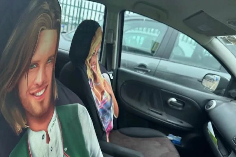 Two 'suspicious people' spotted in a car at Birmingham Airport turned out to be two rather one-dimensional characters - printed on car seat covers