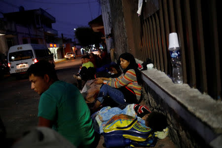 FILE PHOTO: Migrants rest as they wait to enter the Mexican Comission for Refugee Assistance (COMAR) in Tapachula, Mexico, May 13, 2019. REUTERS/Andres Martinez Casares