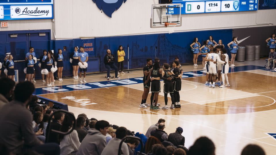 Teams huddle during the basketball game on February 16. - Laura Oliverio/CNN