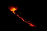 Lava and smoke rise following the eruption of a volcano on the Canary Island of La Palma