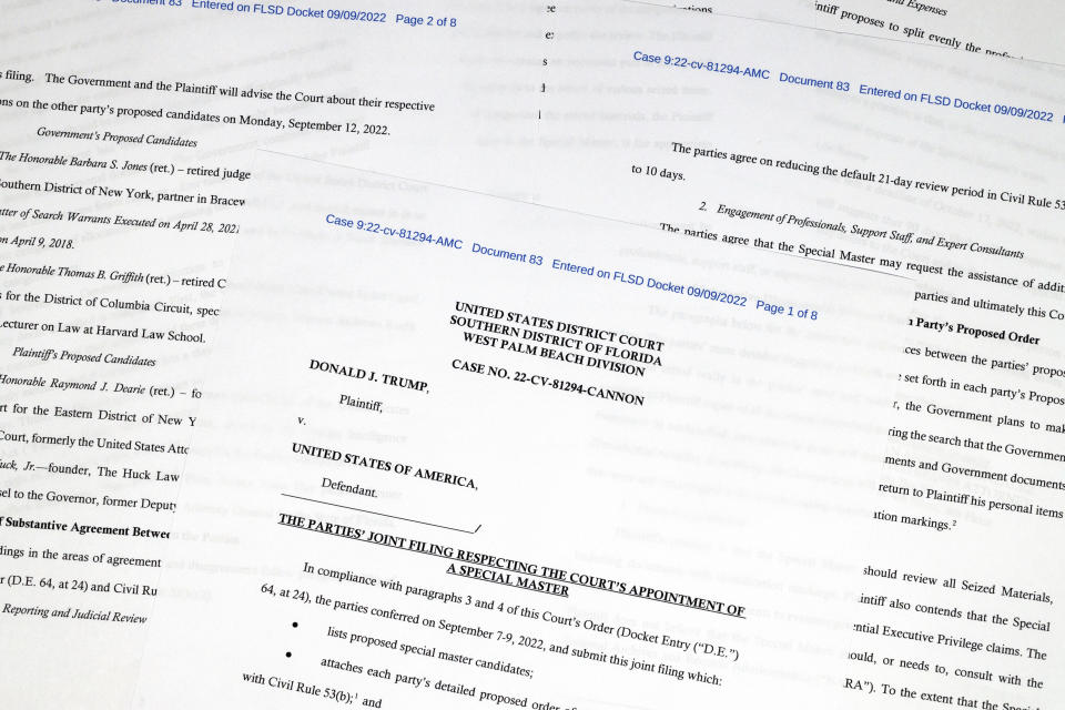 Pages from a court filing by the Justice Department and former President Donald Trump's legal team of proposed candidates to server as an independent arbiter in the investigation into top-secret information seized by the FBI during a search of Trump's Mar-a-Lago estate, is photographed Thursday, Sept. 8, 2022. (AP Photo/Jon Elswick)