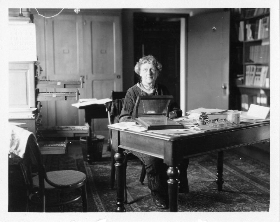 Annie Jump Cannon examines a photographic plates of the night sky on her desk at the Harvard College Observatory.